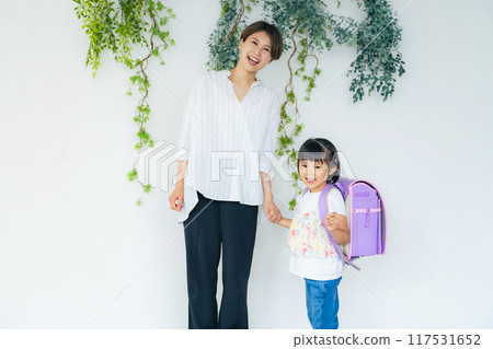 A girl and a mother carrying a school bag 117531652