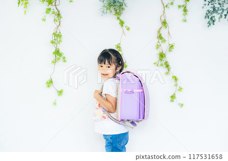 Girls carrying a school bag Girls carrying a school bag 117531658