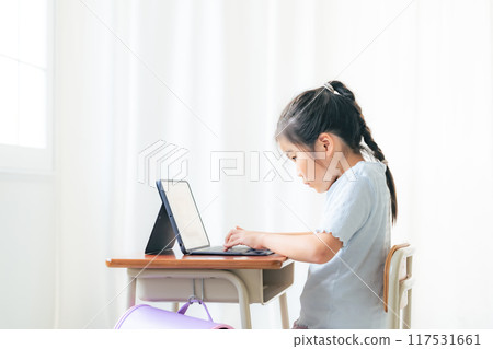 Girl using laptop in classroom Girl using laptop in classroom 117531661