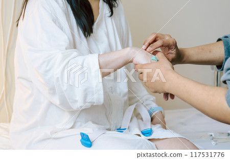 Scene of a medical worker giving an intravenous injection 117531776