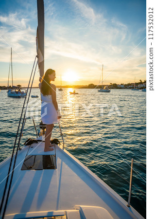 Young woman sailing, young adult lady enjoying summer travel, close-up portrait of female face, summer cruise holidays, European girl tourist traveling in sail boat in Croatia 117532012