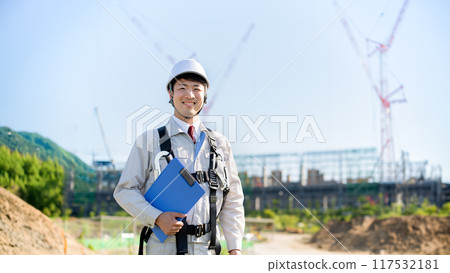 Man standing at a construction site, full harness 117532181