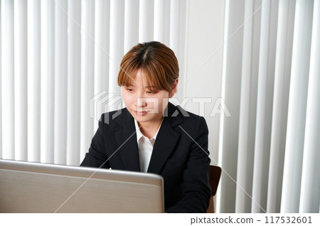 Woman talking on smartphone, suit, working from home Woman talking on smartphone, suit, working from home 117532601