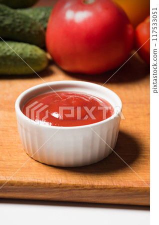 Bowl of ketchup or tomato sauce white in bowl in kitchen, close-up Bowl of ketchup or tomato sauce white in bowl in kitchen, close-up 117533051