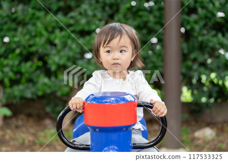 Girls playing with park play equipment 117533325