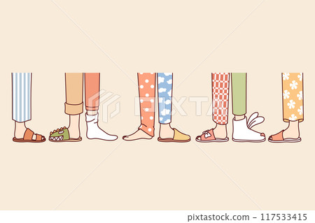 Legs of people from pajama party, in different pants and slippers, attending themed holiday 117533415