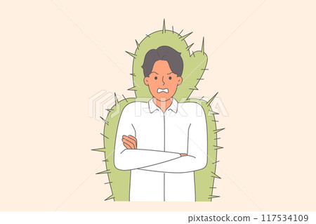 Nervous man experiences aggression and rage due to bad mood, stands in cactus cocoon Nervous man experiences aggression and rage due to bad mood, stands in cactus cocoon 117534109