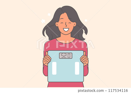 Woman shows scales after losing weight and smiles, rejoicing at good results from fitness and diet Woman shows scales after losing weight and smiles, rejoicing at good results from fitness and diet 117534116