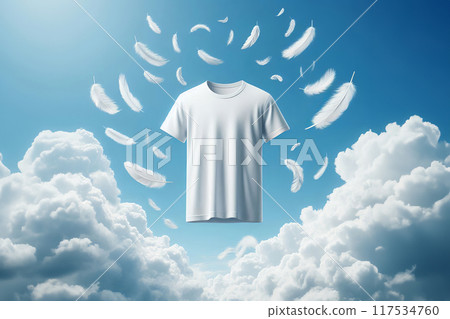 White t-shirt floating against calm blue sky, adorned with light feathers, symbolizing purity. Versatile image for clothing ads 117534760