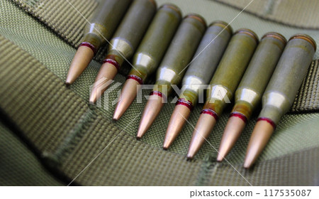 Ammunition in line on the bottom of a military helmet closeup view 117535087