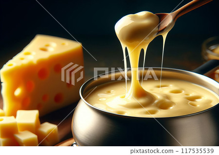 Cheese fondue setup, close up pot with gooey cheese, spoon lifting texture. Alongside, holed cheese block on wooden table, 117535539