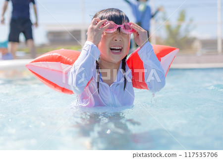 Girl playing in the pool Girl playing in the pool 117535706