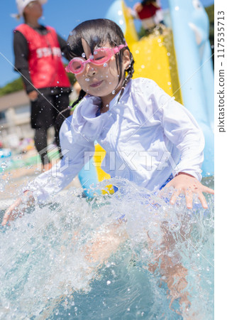 Girls playing on the pool slide 117535713