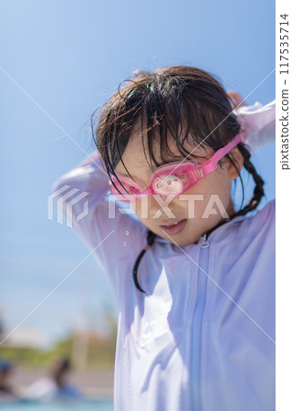 Girl playing in the pool Girl playing in the pool 117535714