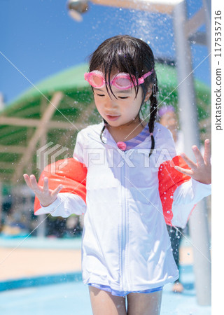 Girl playing in the pool Girl playing in the pool 117535716