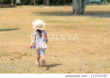 Back view of a girl running in the park 117535767