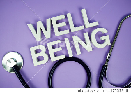 Well Being alphabet letters and stethoscope on purple background, Healthcare concept 117535846