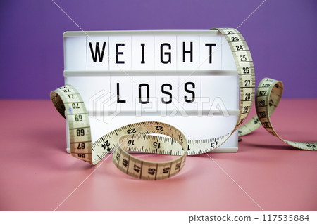 Weight Loss letterboard text on LED Lightbox and Measuring tape on pink and purple background, Healthcare concept Weight Loss letterboard text on LED Lightbox and Measuring tape on pink and purple background, Healthcare concept 117535884