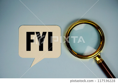 FYI (For Your Information acronym) text on speech bubble with magnifying glass top view on blue background, business concept background 117536228