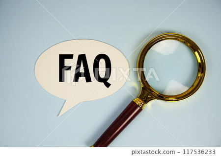 FAQ text on speech bluble with magnifying glass top view on blue background FAQ text on speech bluble with magnifying glass top view on blue background 117536233