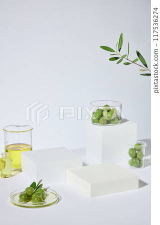 Unique template for advertising pic with natural olive ingredient, decorated with green olive and yellow olive oil. Blank displaying pedestal for cosmetic product showing, which extracted from olive Unique template for advertising pic with natural olive ingredient, decorated with green olive and yellow olive oil. Blank displaying pedestal for cosmetic product showing, which extracted from olive 117536274