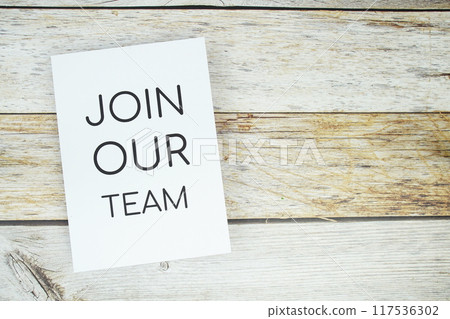 Join Our team text on paper card top view on wooden background Join Our team text on paper card top view on wooden background 117536302