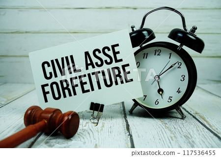 Civil Asset Forfeiture text on paper card with alarm clock and wooden judge gavel on wooden background Civil Asset Forfeiture text on paper card with alarm clock and wooden judge gavel on wooden background 117536455