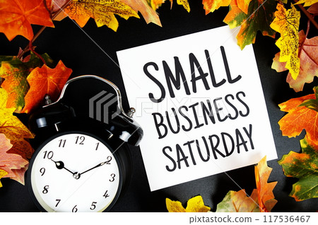 Small Business Saturday text with alarm clock and maple leaf decoration on wooden background Small Business Saturday text with alarm clock and maple leaf decoration on wooden background 117536467