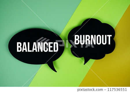 Balanced vs Burnout text on speech bubble top view on green and yellow geometric background 117536551