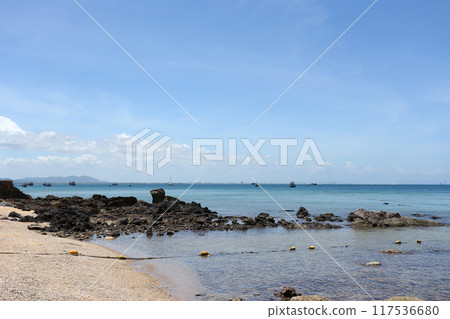 Coastal rocks after low tide against a blue sky at Samae San Bay. Coastal rocks after low tide against a blue sky at Samae San Bay. 117536680
