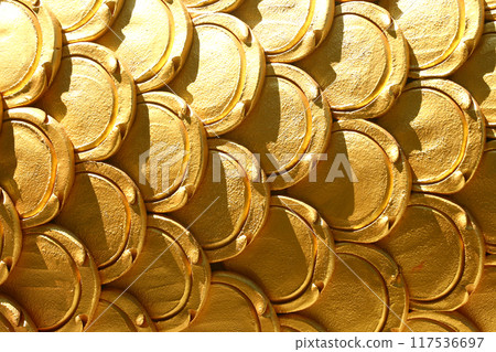 Gold patterns of stucco shaped like fish scales. Gold patterns of stucco shaped like fish scales. 117536697