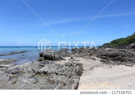 Coastal rocks after low tide against a blue sky at Samae San Bay. Coastal rocks after low tide against a blue sky at Samae San Bay. 117536701