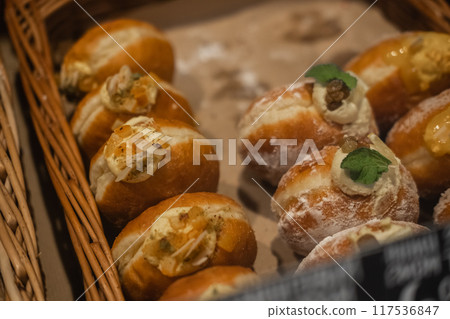 Sweet donuts decorated with a cherry. Blurred foreground, side view 117536847