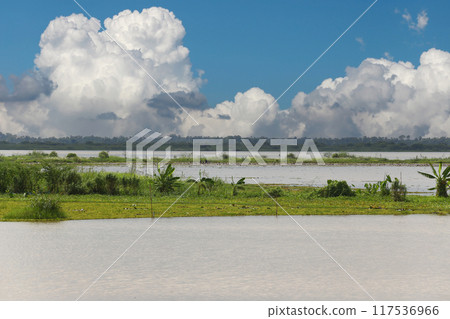 Nong Han surrounded by trees and a sky with white clouds. 117536966