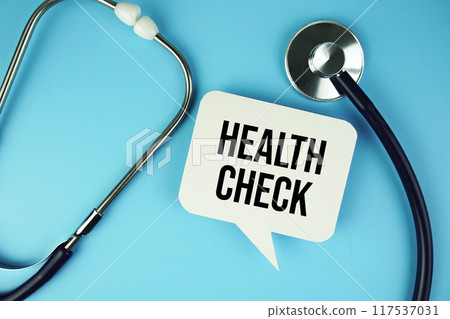 Health Check text on speech bubble with stethoscope top view on blue background Health Check text on speech bubble with stethoscope top view on blue background 117537031