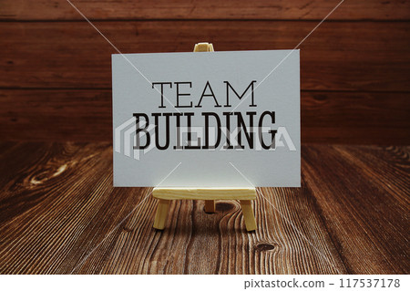 Team Building text on paper card on wooden background Team Building text on paper card on wooden background 117537178