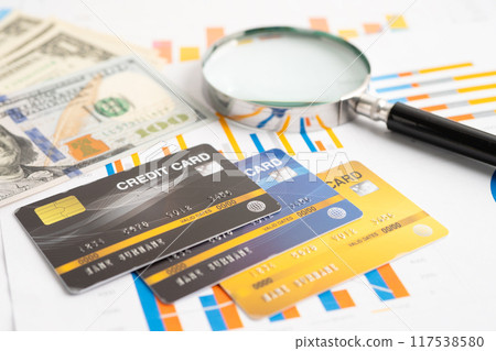 Credit card with US dollar banknotes on graph. Finance business and trading. 117538580