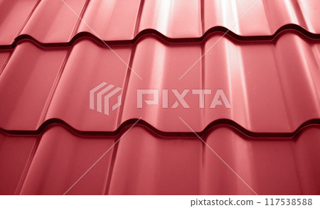 Close-up view lightweight steel roofing sheet. Red color coated modular tile effect roof panel. Traditional metal shingle tiles. Popular profiled metallic pantile mimic clay or concrete slate Close-up view lightweight steel roofing sheet. Red color coated modular tile effect roof panel. Traditional metal shingle tiles. Popular profiled metallic pantile mimic clay or concrete slate 117538588