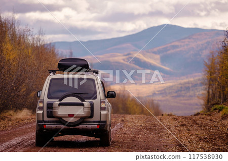 Japanese SUV on scenic autumn road in mountains 117538930