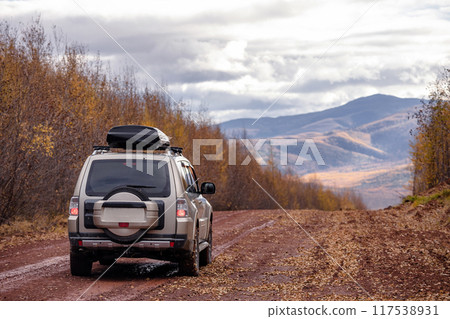 SUV on scenic autumn road in mountains SUV on scenic autumn road in mountains 117538931