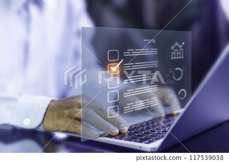 Survey Online concept. Businessman uses laptop and manages online survey. productivity checklist and filling survey form online, answer questions of test. Education futuristic technology and learning. 117539038