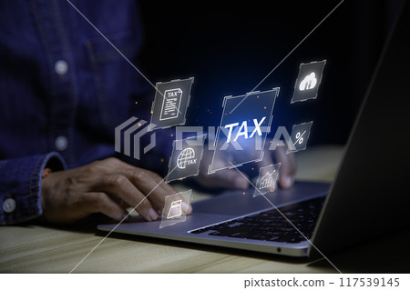 income tax concept. Businessman using laptop analyzing data to online income tax form. tax system icon around. pay online income tax. futuristic virtual screen interface technology.. income tax concept. Businessman using laptop analyzing data to online income tax form. tax system icon around. pay online income tax. futuristic virtual screen interface technology.. 117539145