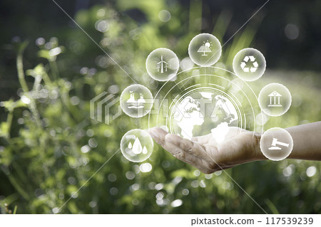 green energy concept. Global warming icons set on hands with nature green background. Net zero 2050 green energy icon around Carbon Neutral in industry. Net zero emissions concept. innovation idea. green energy concept. Global warming icons set on hands with nature green background. Net zero 2050 green energy icon around Carbon Neutral in industry. Net zero emissions concept. innovation idea. 117539239