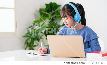Girl wearing headphones and studying on a laptop 117541169