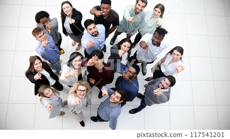 multicultural successful business group looking up in office corridor multicultural successful business group looking up in office corridor 117541201