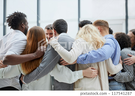 Group of happy positive smiling multiethnic men and women from different mixed race countries standing in a circle 117541287