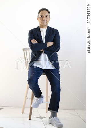 A man in his early 60s looking at the camera 117541309