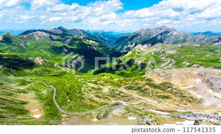 A breathtaking panoramic view showcases the lush green valleys and towering mountains along the Grossglockner High Alpine Road, inviting exploration and adventure. A breathtaking panoramic view showcases the lush green valleys and towering mountains along the Grossglockner High Alpine Road, inviting exploration and adventure. 117541335