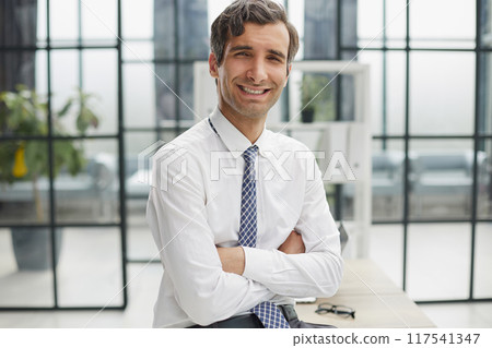 Confident businessman with black folder in the office Confident businessman with black folder in the office 117541347