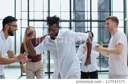 Happy group of business team celebrating a good job in the office Happy group of business team celebrating a good job in the office 117541371